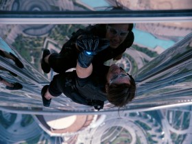 Tom Cruise climbing a building